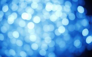 Captivating blue bokeh lights create a dreamy atmosphere during a nighttime celebration photo