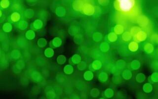 Vibrant green bokeh lights create a calming atmosphere in a natural setting during twilight hours photo