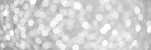 Soft white bokeh pattern creates a dreamy atmosphere suitable for various artistic projects or festive occasions photo