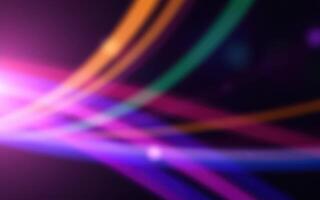 Colorful light trails create a vibrant abstract background at night for artistic expression and design purposes photo