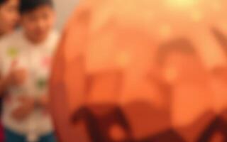 Children engaged in festive Halloween activities while preparing jack-o'-lanterns at a community event in October photo