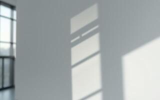 Shadows cast by sunlight create a serene atmosphere in a bright, minimalist room during the afternoon photo
