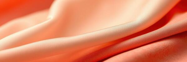 Soft peach fabric draping elegantly in natural light with gentle folds and curves for a calming effect photo