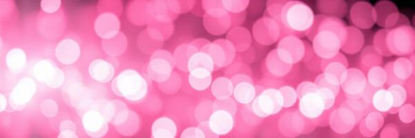 Soft pink bokeh lights create a dreamy atmosphere suitable for celebrations and events during evening hours photo