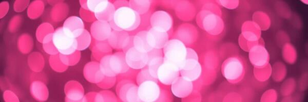 Bright pink bokeh lights create a festive atmosphere in a nighttime celebration setting photo