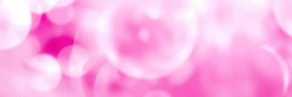 Soft pink bubbles floating against a blurred background create a dreamy atmosphere for relaxation and enjoyment photo