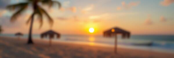 Majestic sunset over a serene beach with palm trees and umbrellas during golden hour photo