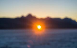 Sunset over the mountains with a blurred horizon and soft colors at dusk photo