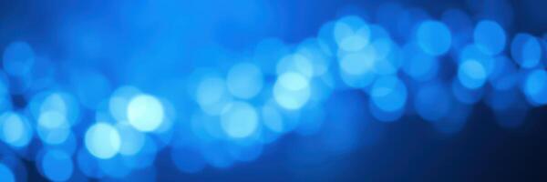 Soft blue bokeh lights create a calming atmosphere in an indoor setting during evening hours photo