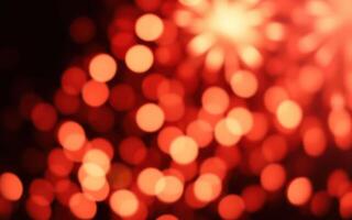 Vivid red bokeh lights create an atmosphere of celebration during a nighttime fireworks event photo