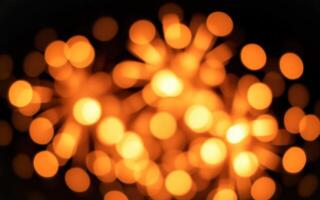 Bright orange firework display lighting up the night sky at a festive celebration in a vibrant setting photo