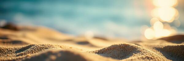Soft golden sand glistens under the sun by the tranquil ocean at sunset photo