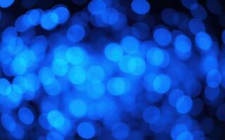 Vibrant blue bokeh lights create a soothing atmosphere at a nighttime gathering photo