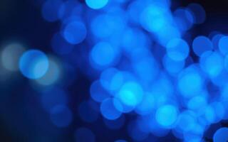 Illuminated blue bokeh lights create a dreamy atmosphere in a nighttime setting photo