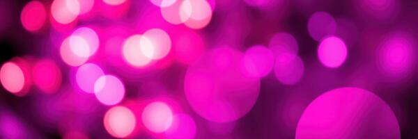 Colorful bokeh lights create a visually stunning background in shades of pink and purple at a nighttime celebration photo