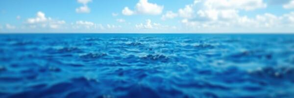 Tranquil ocean view under a vivid blue sky with soft clouds on a sunny day photo