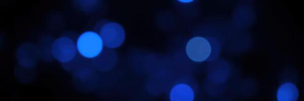 Beautiful blue bokeh lights create a dreamy atmosphere during a festive evening celebration photo