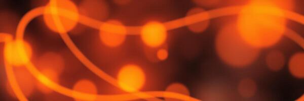 Vibrant orange lights create an abstract design with flowing lines and glowing circles over a dark background photo