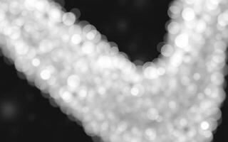Twinkling light reflections create a mesmerizing bokeh effect on a dark background photo