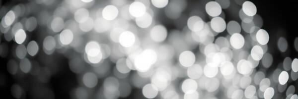 Shimmering light reflections create a mesmerizing bokeh effect in a dark setting during evening hours photo