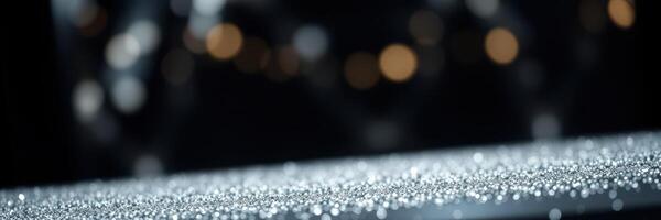 Sparkling droplets create a magical atmosphere on a surface with blurred lights in the background at night photo