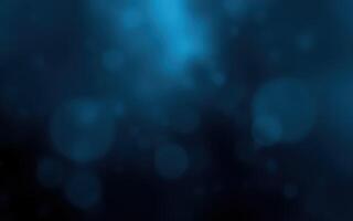 A serene underwater atmosphere with blue hues and softly glowing particles in a tranquil setting photo