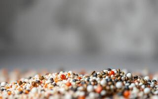 Colorful assortment of grains and seeds arranged on a surface in a bright setting highlighting texture and variety of colors photo