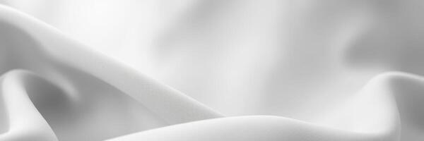 Soft white fabric draping elegantly under natural light in a serene setting photo