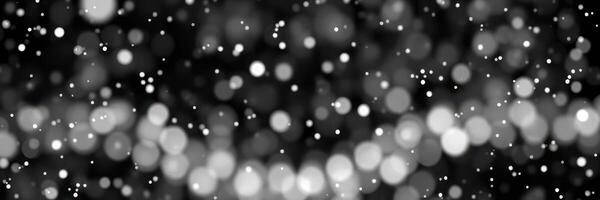 Beautiful bokeh effect with soft white and gray circles creating a magical atmosphere during a winter evening photo