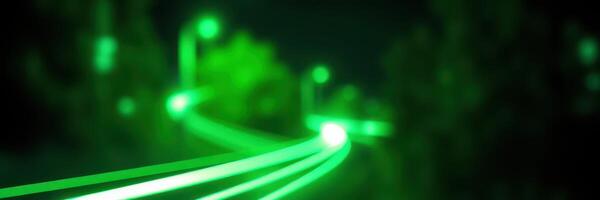 Green light trails illuminate a winding path in a nighttime urban setting photo