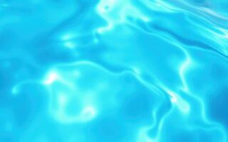 Clear blue water ripples in a sunny swimming pool on a warm afternoon photo