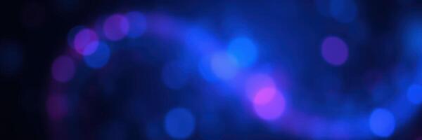 Colorful abstract swirl with blue and purple bokeh lights creating a dreamy atmosphere in an artistic setting photo