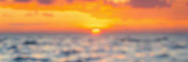 Colorful sunset over the ocean creates a serene atmosphere with waves gently lapping against the shore photo