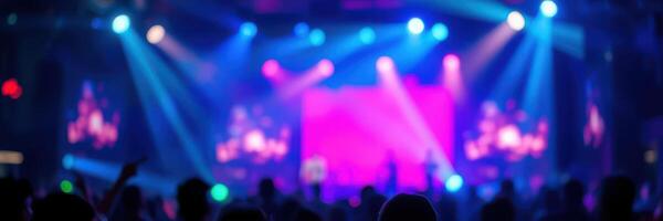 Colorful lights illuminate concert crowd during vibrant music show in urban venue photo