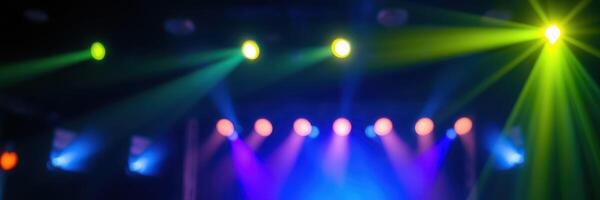 Colorful stage lights create an energetic atmosphere during a live music event at a local venue photo