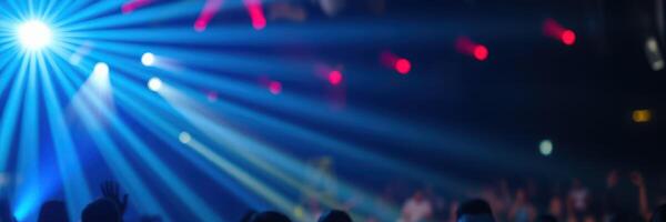 Colorful lights illuminate a lively dance floor at a nighttime event in a vibrant venue photo
