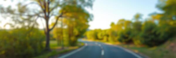 Scenic winding road through a lush green landscape during late afternoon photo