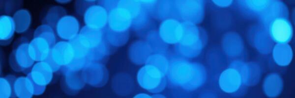 Soft blue bokeh lights create a calming atmosphere during a serene evening gathering in a cozy outdoor setting photo