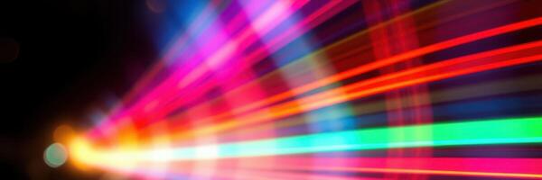 Colorful light streaks blurring across a dark background create a vibrant visual display at night photo