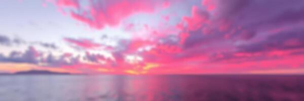 Vibrant sunset over the tranquil ocean reflecting pink and purple hues during twilight photo