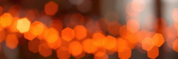 Warm orange bokeh lights create a cozy atmosphere in a dimly lit space during an evening gathering photo