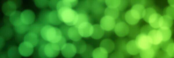 Vibrant bokeh lights create a mesmerizing green backdrop in a lively outdoor setting during a summer evening photo