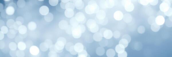 Soft bokeh lights create a dreamy atmosphere in a serene blue background during daylight hours photo