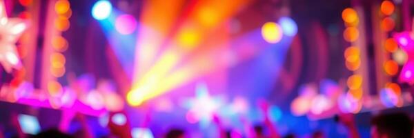 Colorful light display and energetic crowd at a vibrant music event during nighttime celebration in an urban setting photo