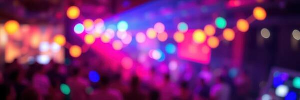 Colorful lights illuminate a lively indoor celebration with a crowd enjoying music and dancing late into the night photo