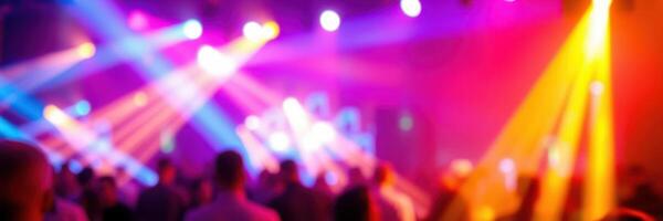 Vibrant club atmosphere filled with dancing crowds under colorful lights at night photo