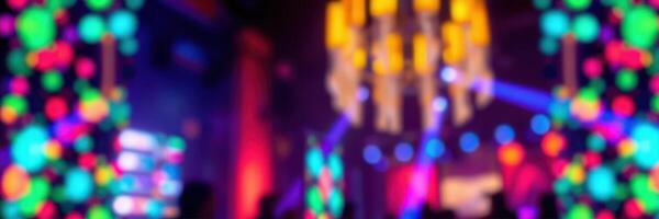 Colorful lights create an energetic atmosphere during a lively electronic music event at a vibrant venue photo