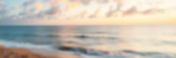 Evening sunset casts warm colors over calm ocean waters by the beach in a serene landscape photo