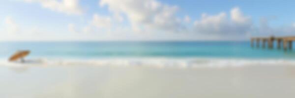 Relaxing beach scene on a sunny day with gentle waves and a clear blue sky photo