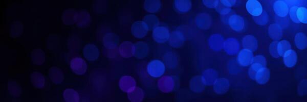 Vibrant blue bokeh lights creating a mesmerizing visual effect in a dark backdrop photo